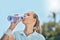Woman, tennis player and drinking water for hydration after workout, exercise or intense training in nature. Sporty