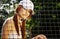 Woman tennis player sitting behind the net