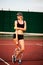 Woman tennis player wearing cap having rest while standing on te
