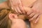 Woman on therapeutic body massage by doctor masseur in clinic, shoulder closeup.