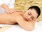 Woman on therapy massage of back in spa salon