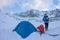 Woman with a thermos at blue tent in the base camp in the mountains