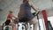 Woman with thick legs pedalling on stationary bike in the gym, weight loss