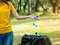 The woman threw the bottle cap after use into the trash prepared for storage for recycling and reuse