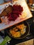 Woman throw sliced beetroot on pan with vegetables