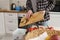 Woman throwing food peels in a domestic compost bin. Female person recycling organic food waste in a bokashi container with