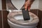 Woman throwing mobile phone in the toilet bowl