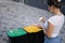 Woman throwing out in recycling bin washed and empty shampoo and deodorant bottles. Female looks at the packages to find