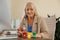 Woman throwing paper into mini recycling bin