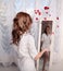 Woman throwing rose petals near the mirror