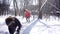 Woman throwing snowball on her guy in winter in playful mood