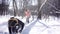 Woman throwing snowball on her guy in winter in playful mood