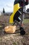 A woman throws branches at the Garden Shredder. which is designed to chop up scraps of trees or shrubs