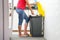 A woman throws garbage in the trash in the kitchen