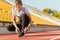 Woman tie shoelaces at outdoor stadium