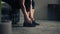 Woman ties her shoes before starting workout at home or gym. Active woman tying up shoelaces during training.legs and