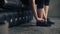 Woman ties her shoes before starting workout at home or gym. Active woman tying up shoelaces during training.legs and