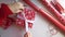 Woman ties a ribbon bow and wrapping presents