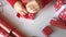 Woman ties a ribbon bow and wrapping presents