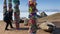 A woman ties a ribbon to the sacred serge post near Shamanka, Cape Burkhan.