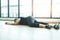 Woman, tired, lying exhausted on the floor. After exercising in a hard workout.