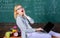 Woman tired teacher work laptop classroom chalkboard background. Working conditions which prospective teachers must