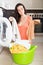 Woman tired and washing clothes in machine