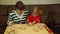 Woman and toddler girl preparing gingerbread for family Christmas eve dinner.