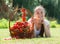 Woman with tomato harvest in garden