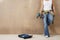 Woman With Toolbelt And Drill Leaning Against Wall