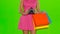 Woman tosses the empty wallet. Green screen