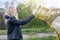 A woman tosses a plastic bottle into a plastic container for collection. Recycling and disposal of plastic. The concept of