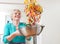 Woman Tossing Vegetables In Wok Whilst Cooking