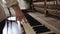 Woman touch keyboard of vintage wooden piano