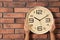 Woman touching clock on brick wall, space for text