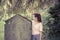 Woman touching a moss overgrown tombstone