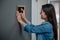 Woman touching smart home device choosing mode