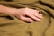 Woman touching soft linen fabric, closeup view