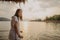 Woman tourist admire the beautiful nature of the lake with warm sunset sky