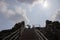 Woman tourist in Angkor Wat temple, Cambodia. Female tourist climb a stair in archaeological site. Phnom Bakheng temple