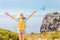 Woman tourist with backpack and greek flag travelling by the footpath in Greece