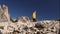 Woman tourist climbs mountain range Tre Cime di Lavaredo