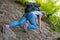 Woman tourist climbs the rock. Tourism and Hiking. Bottom view