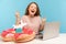 Woman tourist feeling crazy and screaming with happiness, sitting at desk with passport and paper airplane