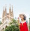 Woman tourist in front of the famous Sagrada Familia landmark in Barcelona