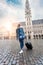 Woman tourist goes with a suitcase at the Grand Place in Brussels, Belgium