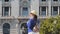 Woman Tourist in hat with a backpack in the center of Porto