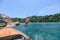 Woman tourist jumping on wooden boat in tropical sea