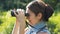 Woman tourist looking through binoculars closeup.