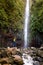 Woman tourist and main waterfall at levada 25 fountains in Rabacal, Madeira island